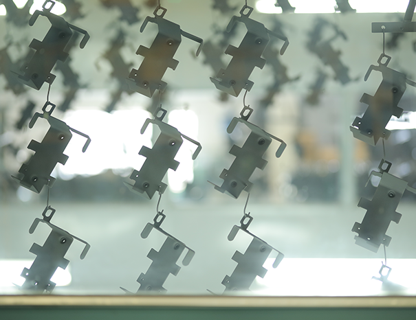 Conveyorized powder-coating line applying corrosion-resistant finish to metal parts
