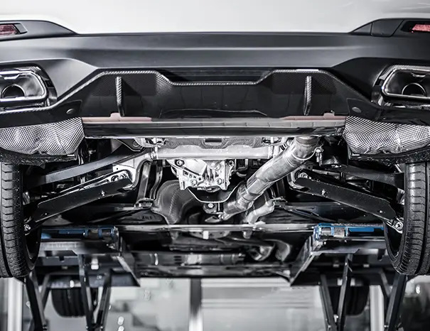 Precision-stamped automotive chassis frame component in an industrial press shop