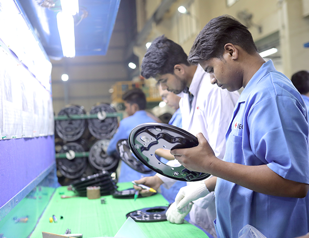 Quality engineer reviewing an inspection checklist on a factory floor