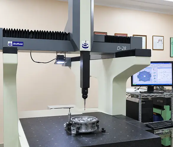 Coordinate measuring machine checking hole positions on a steel bracket