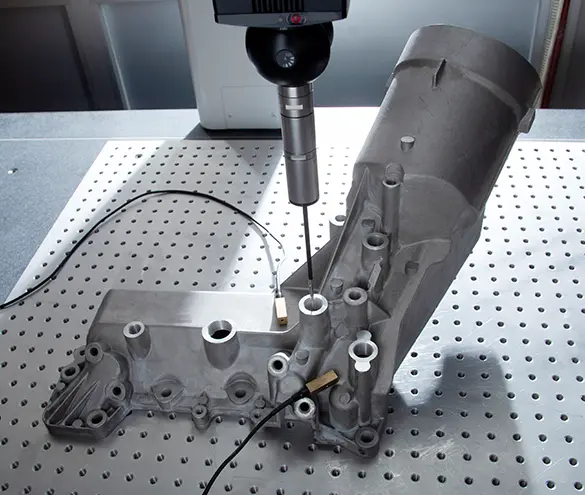 CMM inspection of a stamped engine bracket against the drawing