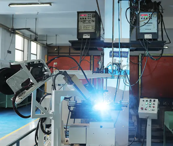 Robotic MIG welding cell joining an engine sub-assembly