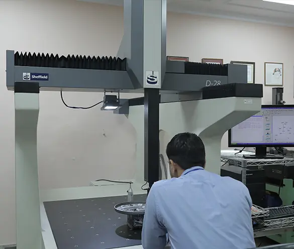 Coordinate measuring machine checking a welded steel bracket