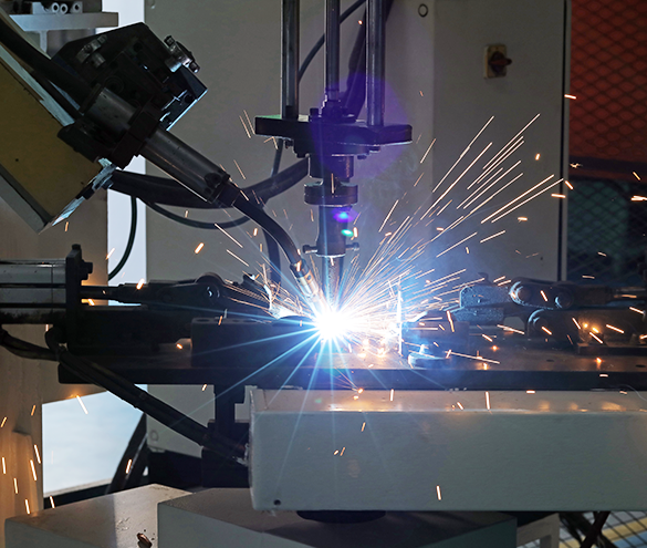 Robotic welding cell joining stamped brackets into a sub-assembly
