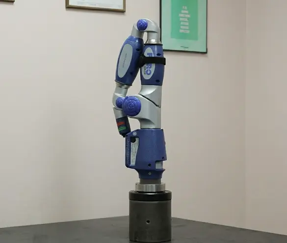 Measuring arm checking a welded automotive component