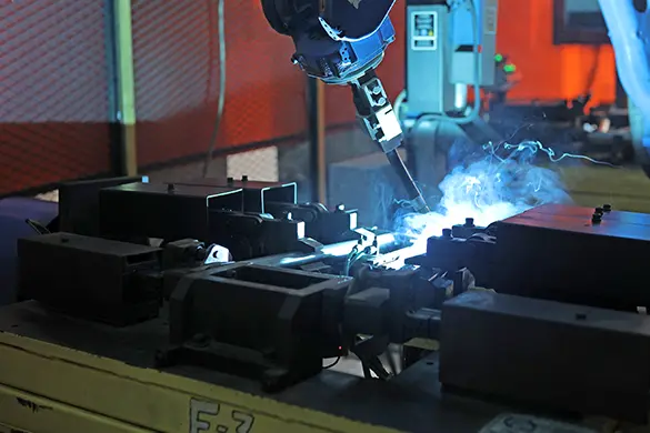 Welded steel mounting brackets for a tractor frame