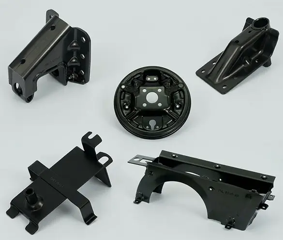 Welded steel bracket sub-assemblies on a workbench